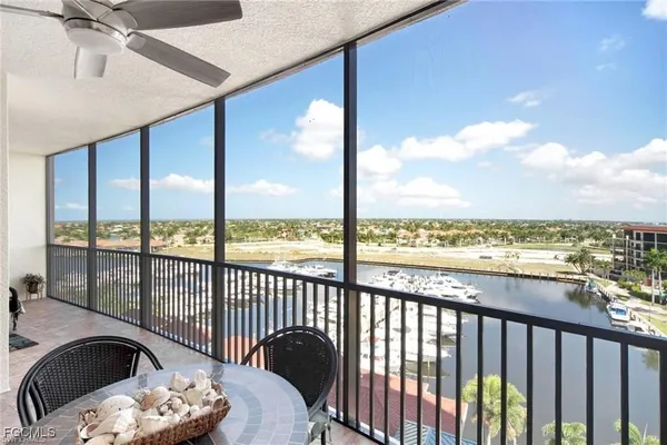 a view of a balcony with chair and city view