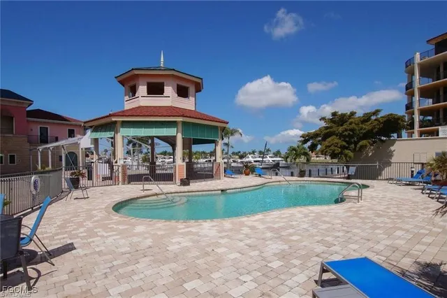 a view of a patio with a dining table and chairs under an umbrella