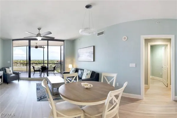 a dining room with furniture wooden floor a chandelier