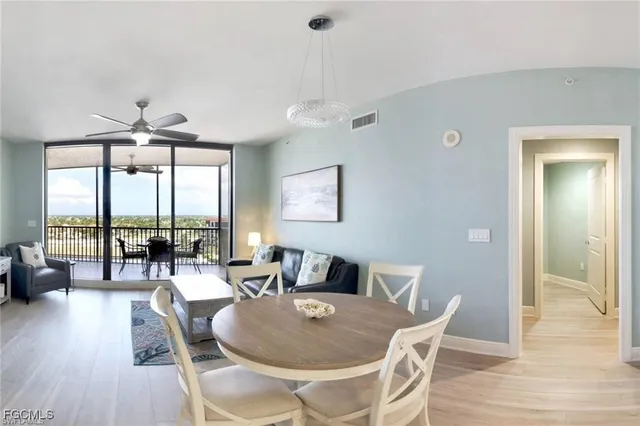 a dining room with furniture wooden floor a chandelier