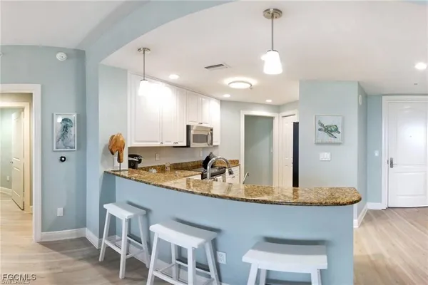 a kitchen with center island table and chairs