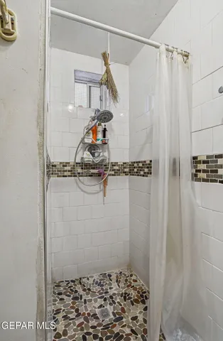 a kitchen with stainless steel appliances a table and chairs in it