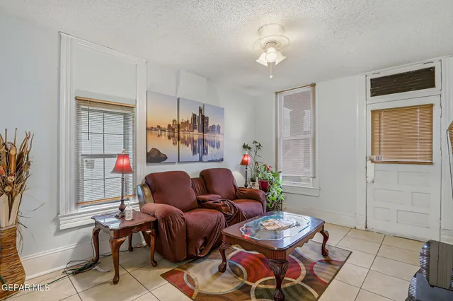 a bedroom with a bed and a flat tv screen on dresser