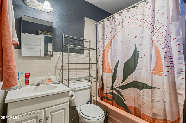a backyard of a house with barbeque oven table and chairs