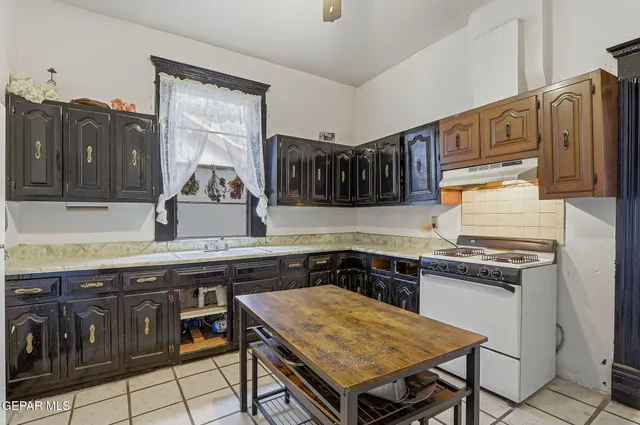 a kitchen with a table and refrigerator