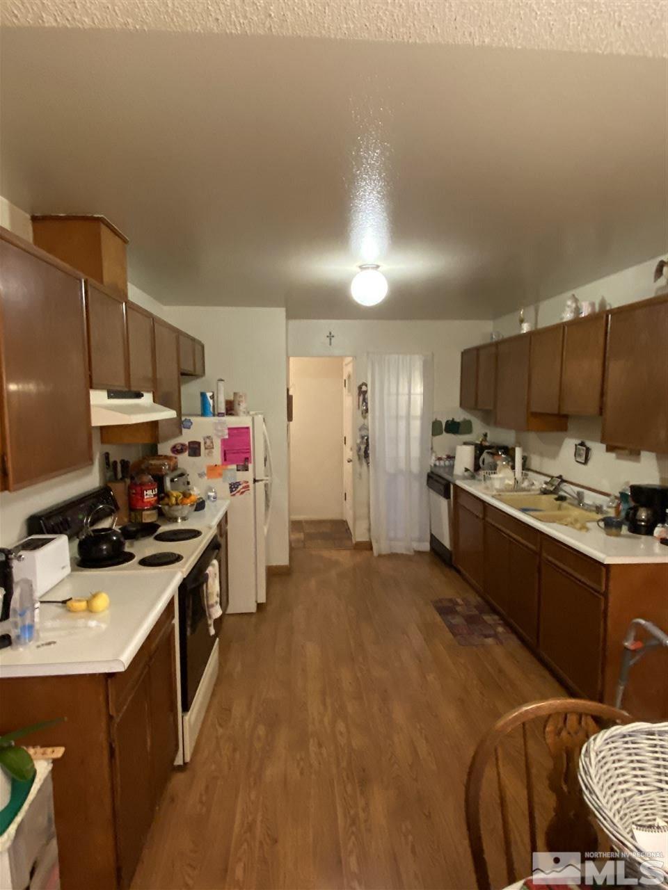 3235 Pierremont Road Reno, NV 89503 - Photo 4 of 20 a kitchen with stainless steel appliances a stove a sink dishwasher a refrigerator and a oven