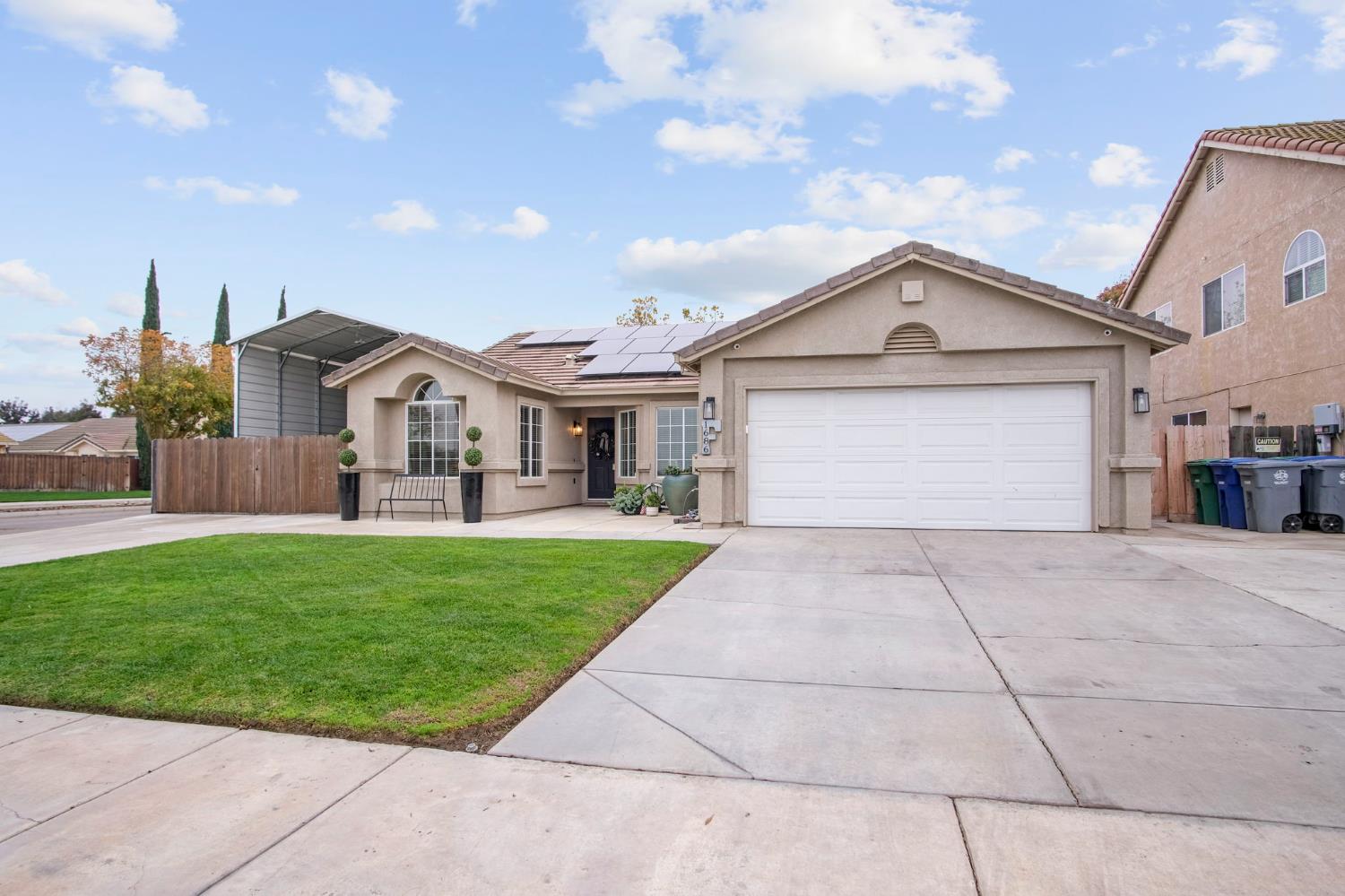 a front view of a house with a garden and yard