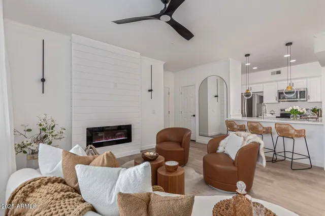 a living room with furniture fireplace and a flat screen tv
