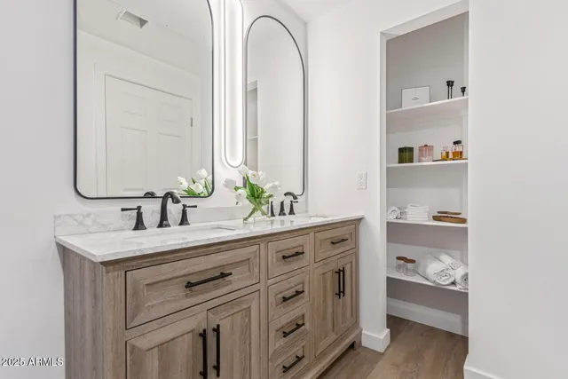 a bathroom with a double vanity sink and a mirror
