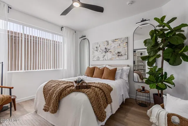 a bedroom with a bed plant and a window