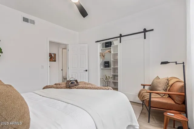 a bedroom with a bed and chair