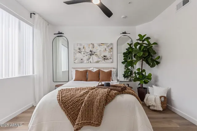 a bedroom with a bed and a potted plant