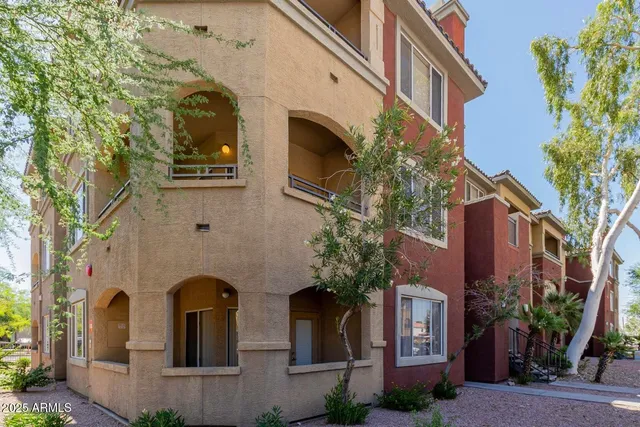 a view of a hallway with wooden floor and windows