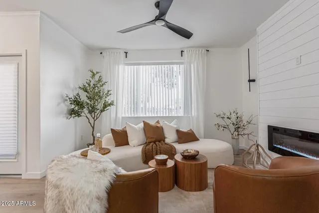 a living room with furniture and a potted plant