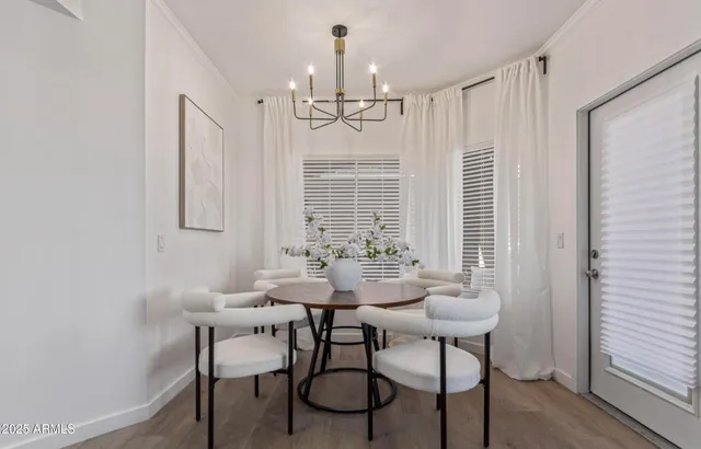 a view of a dining room with furniture and chandelier