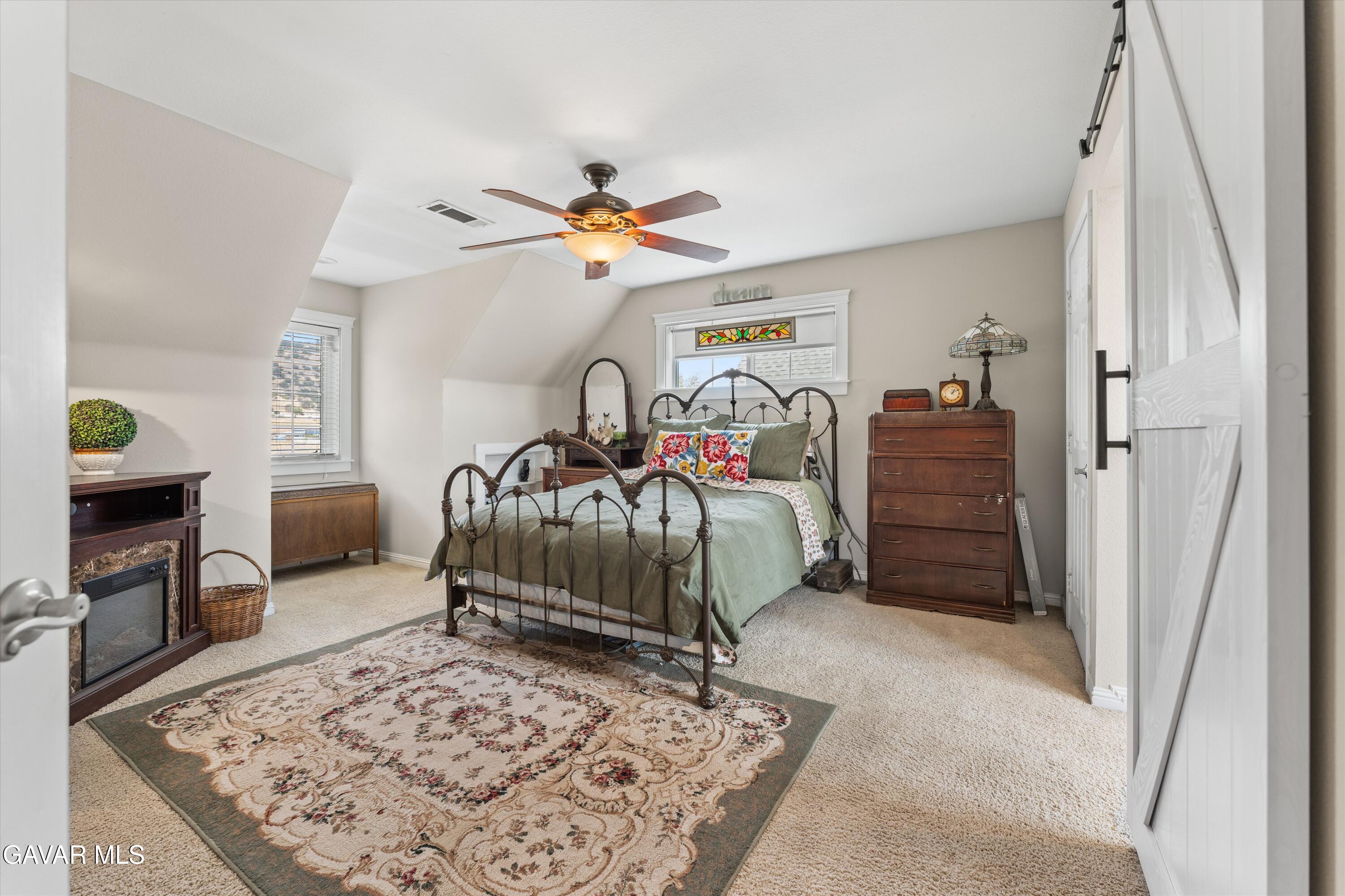 27450 Harness Drive Tehachapi, CA 93561 - Photo 20 of 44 a bedroom with a bed a dresser and a walk in closet