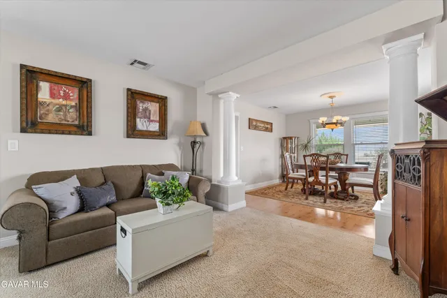 a kitchen with stainless steel appliances granite countertop a refrigerator oven a sink dishwasher and white cabinets with wooden floor