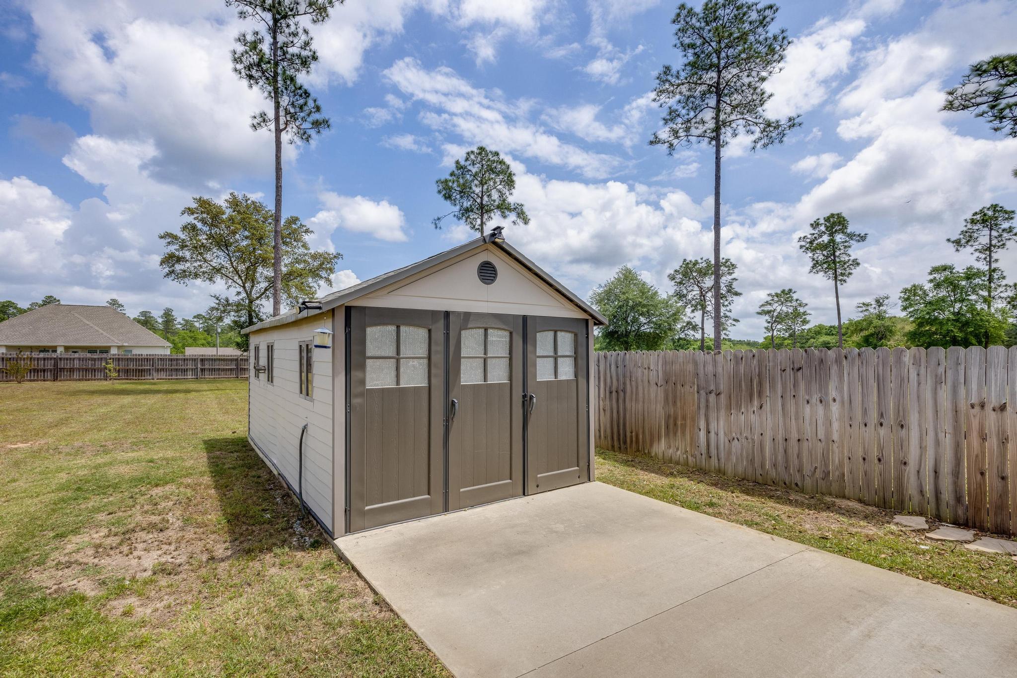 3948 Painter Branch Road Crestview, FL 32539 - Photo 54 of 58 a front view of a house with a yard and fountain