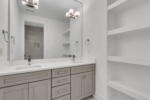 a bathroom with a sink double vanity and a mirror