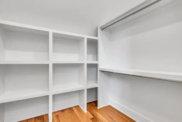 a view of room with wooden floor and cabinets
