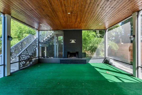 a view of a house with backyard and porch