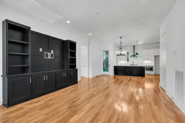 a kitchen with kitchen island sink and cabinets