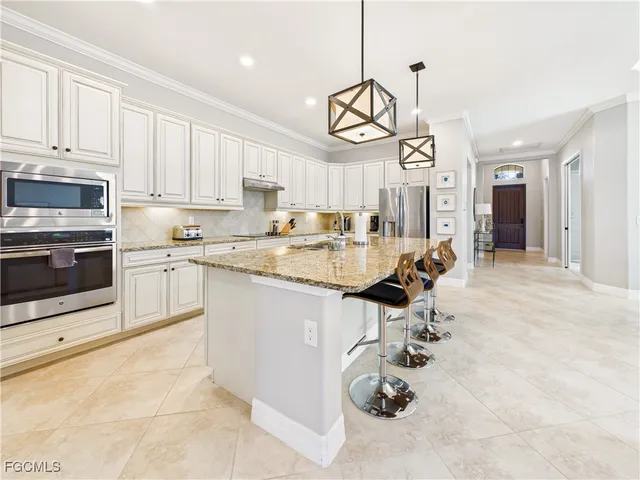 a very nice looking kitchen with a sink appliances and cabinets