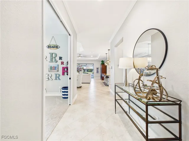 an entryway with wooden floor and a view of living room