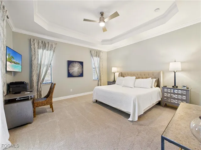 a bedroom with a bed a couch and a chandelier