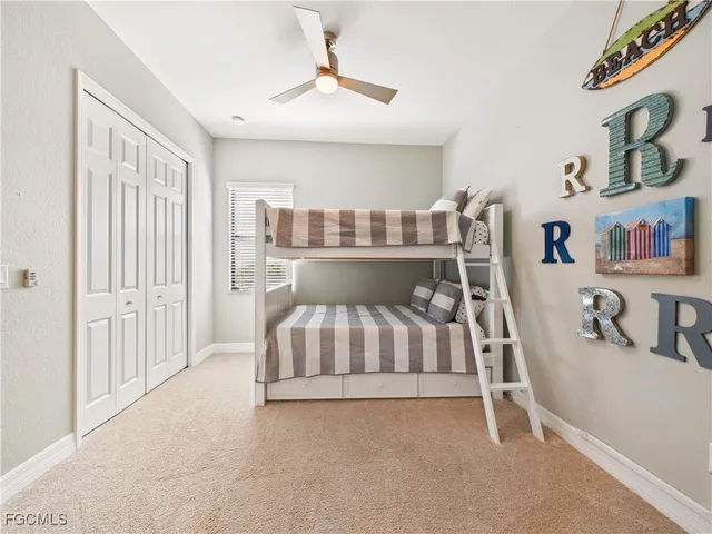 a bed room with a bed and a chair