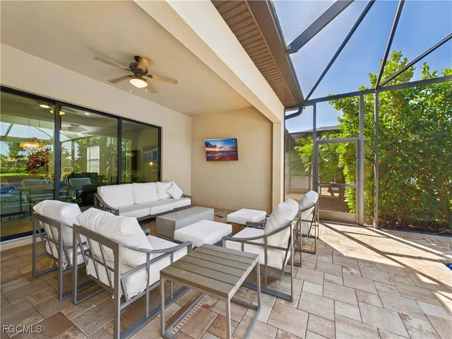 a view of a patio with a dining table and chairs
