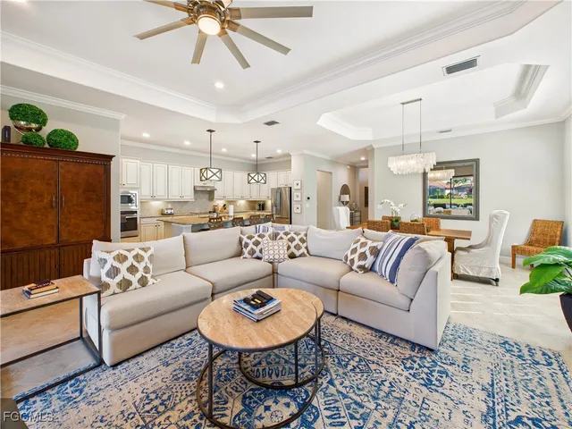 a living room with furniture and a chandelier