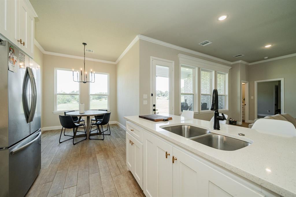 2000 Sweet Springs Road Weatherford, TX 76088 - Photo 12 of 40 a kitchen with stainless steel appliances granite countertop a sink a stove and refrigerator