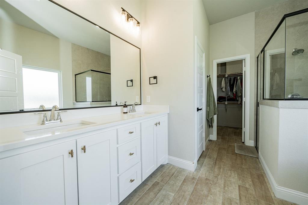 2000 Sweet Springs Road Weatherford, TX 76088 - Photo 19 of 40 a bathroom with a double vanity sink and mirror