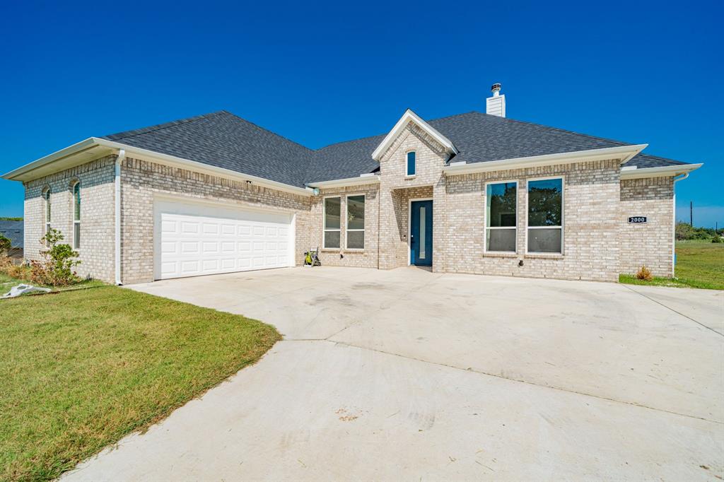 2000 Sweet Springs Road Weatherford, TX 76088 - Photo 2 of 40 a front view of a house with a yard and garage