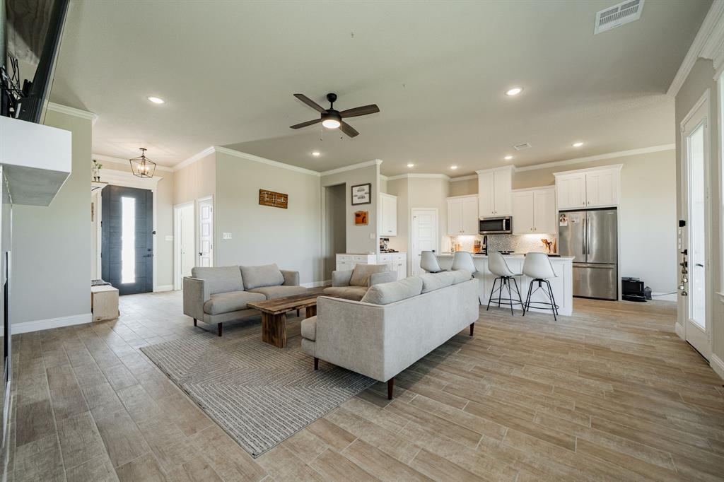 2000 Sweet Springs Road Weatherford, TX 76088 - Photo 30 of 40 a living room with furniture and a wooden floor
