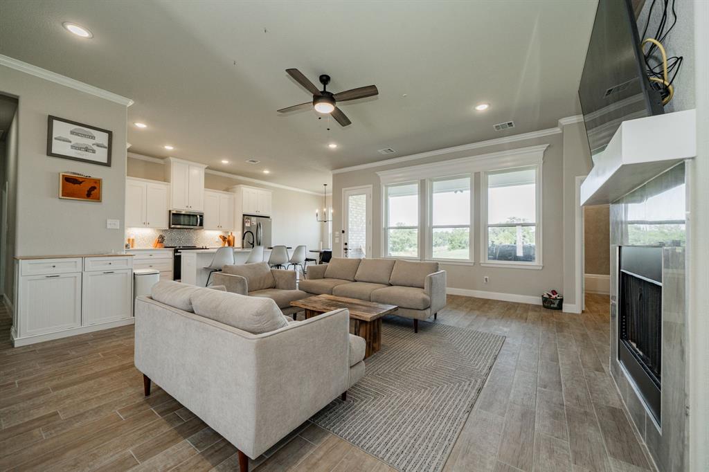 2000 Sweet Springs Road Weatherford, TX 76088 - Photo 31 of 40 a living room with furniture and a fireplace