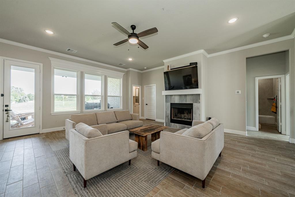 2000 Sweet Springs Road Weatherford, TX 76088 - Photo 32 of 40 a living room with furniture fireplace and a flat screen tv