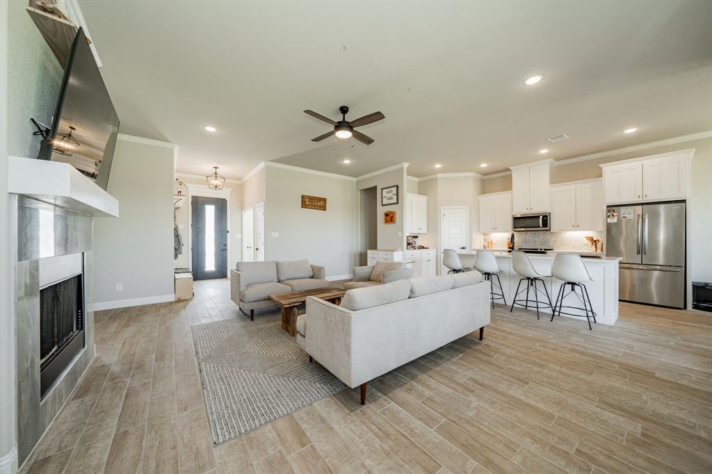 2000 Sweet Springs Road Weatherford, TX 76088 - Photo 33 of 40 a living room with furniture flat screen tv and a fireplace