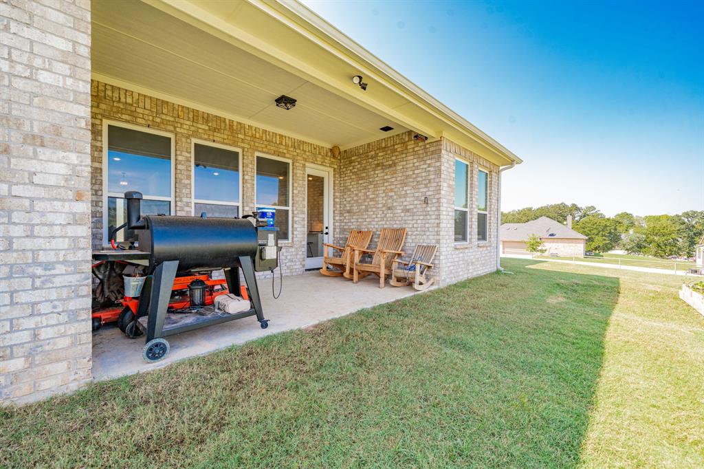 2000 Sweet Springs Road Weatherford, TX 76088 - Photo 35 of 40 a view of a patio with table and chairs near a barbeque