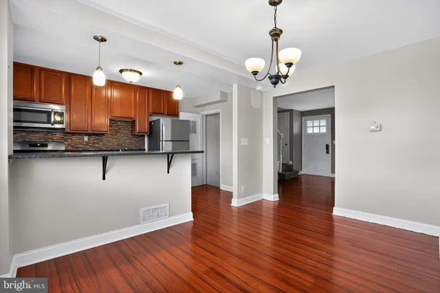 a view of kitchen with sink microwave and cabinets