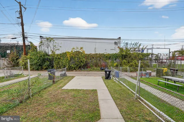 a view of a swimming pool with a patio and plants
