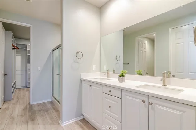 a bathroom with a double vanity sink and mirror