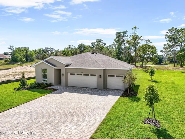 a house with green field in front of it