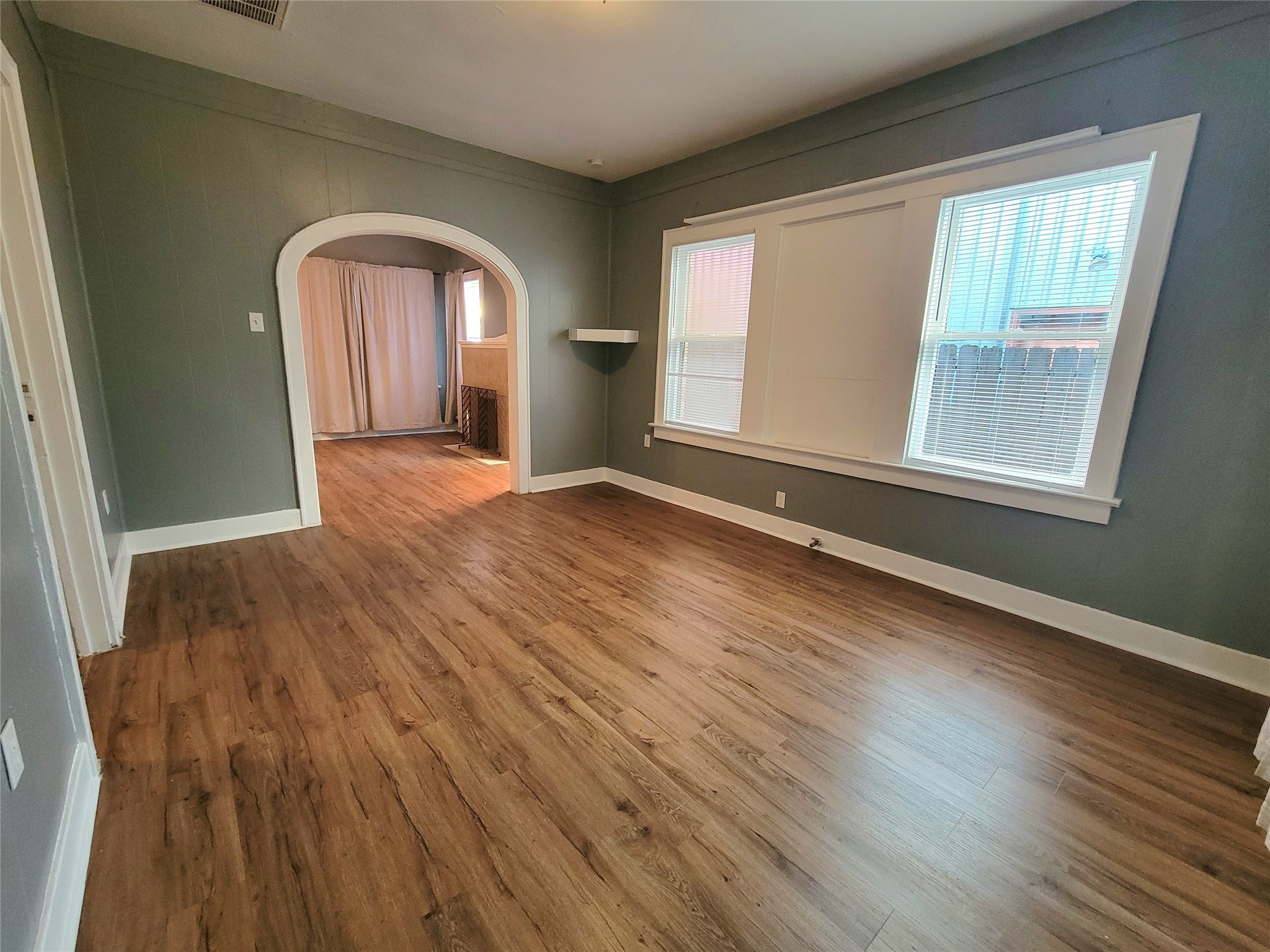 2811 Chenevert Street Houston, TX 77004 - Photo 11 of 26 an empty room with wooden floor and windows
