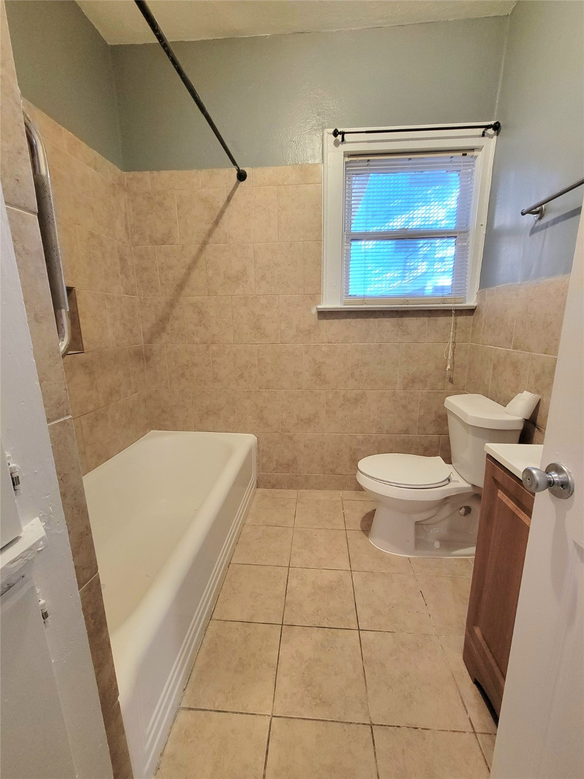 2811 Chenevert Street Houston, TX 77004 - Photo 18 of 26 a bathroom with a toilet a sink a window and vanity