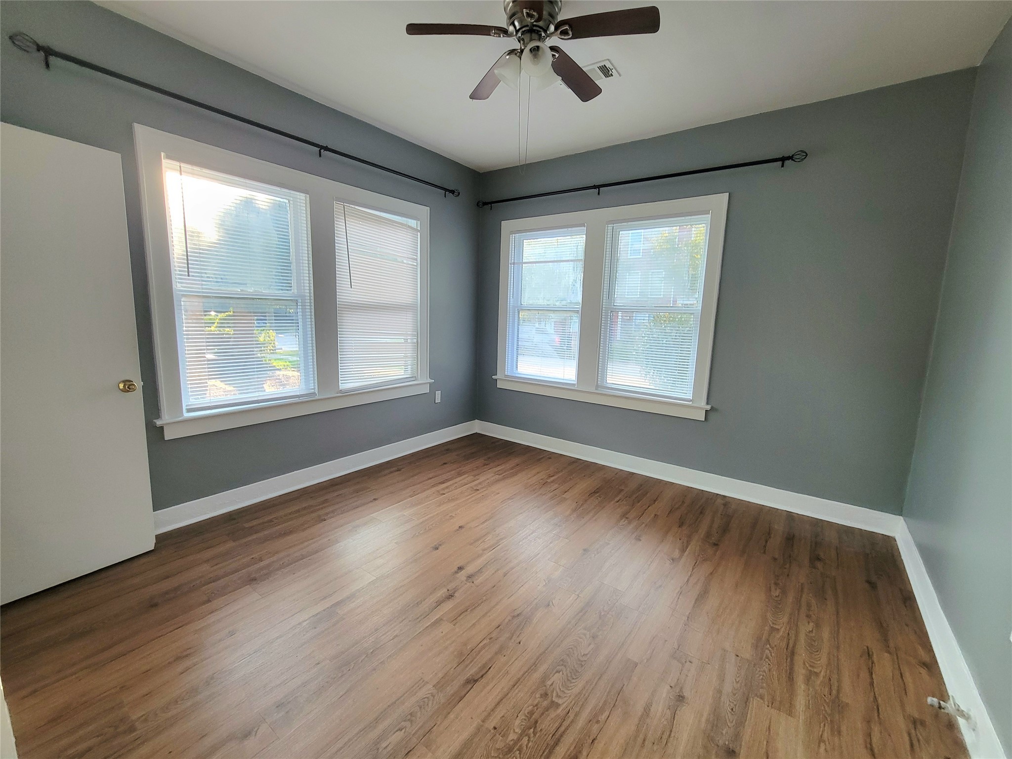 2811 Chenevert Street Houston, TX 77004 - Photo 20 of 26 an empty room with wooden floor fan and windows