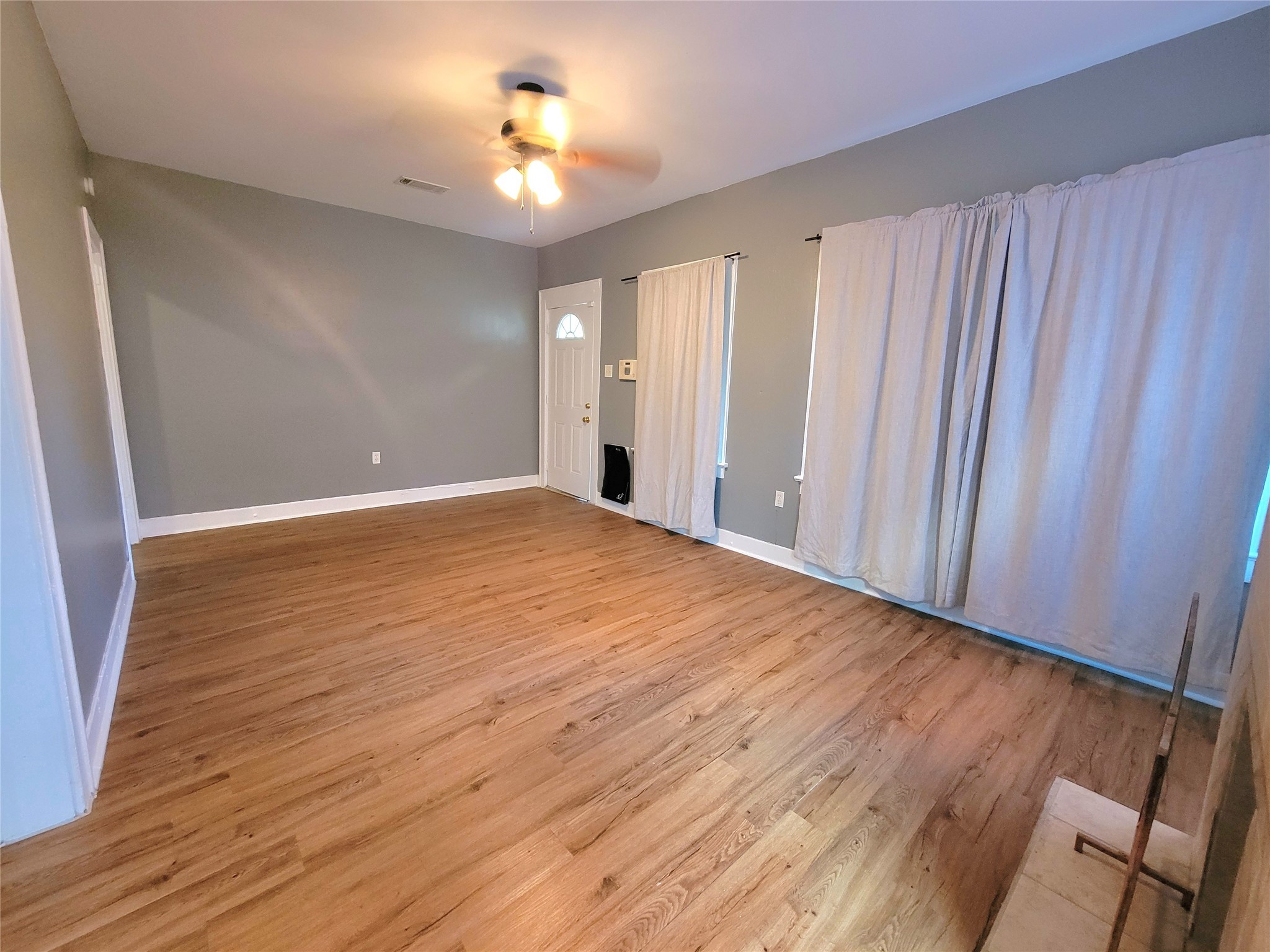 2811 Chenevert Street Houston, TX 77004 - Photo 8 of 26 wooden floor in an empty room with a window