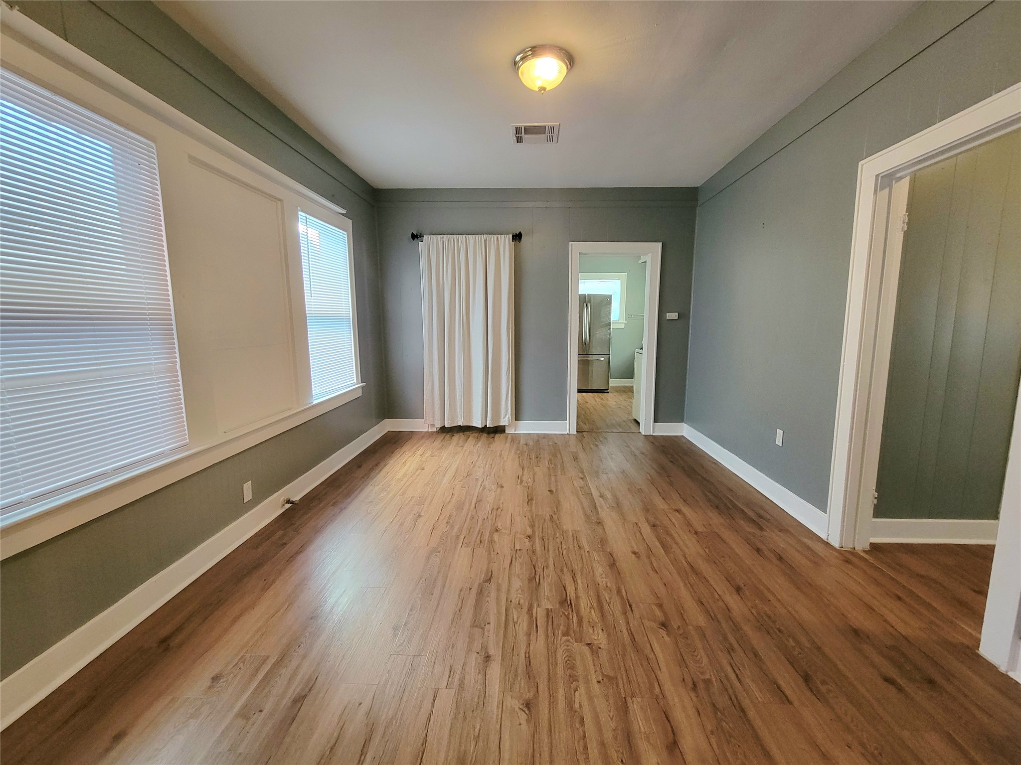 2811 Chenevert Street Houston, TX 77004 - Photo 10 of 26 a view of a room with wooden floor and window