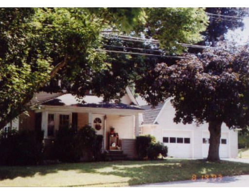 a view of house with a yard